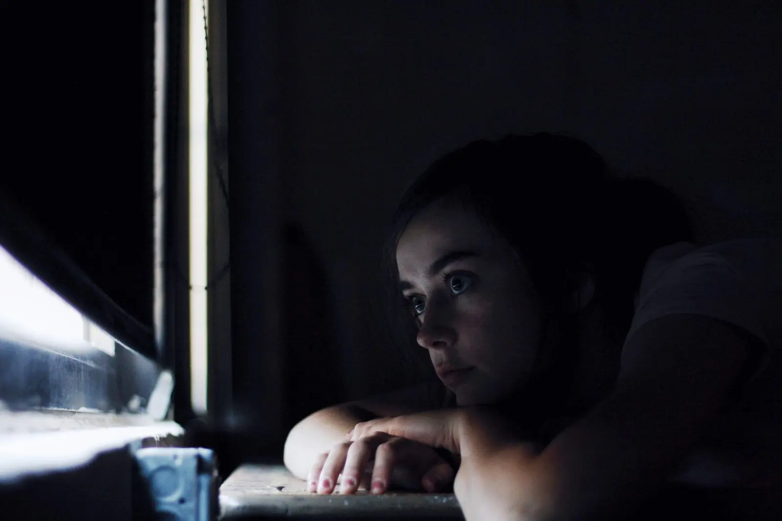 A quiet heartbreak reflection scene with a journal and soft light.