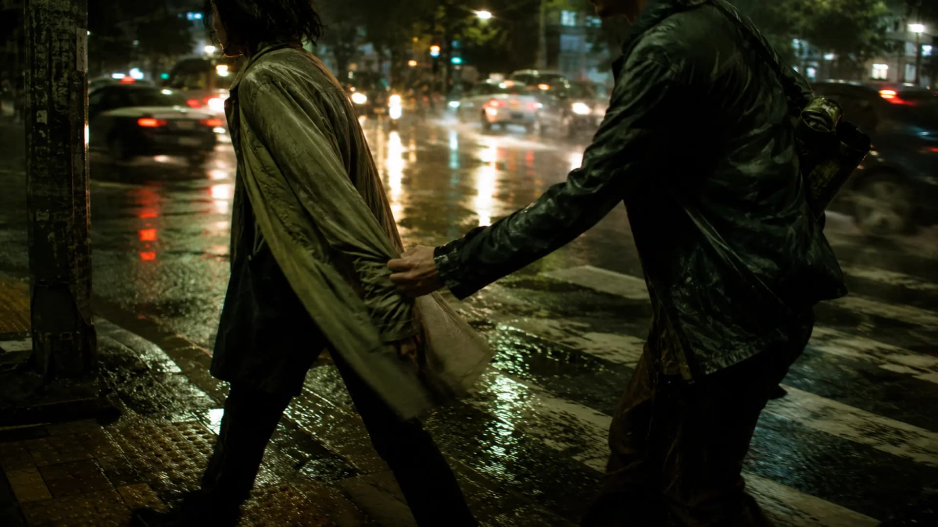 Two friends crossing a rainy street, one reaching for the other's sleeve in a moment that feels more than friendly
