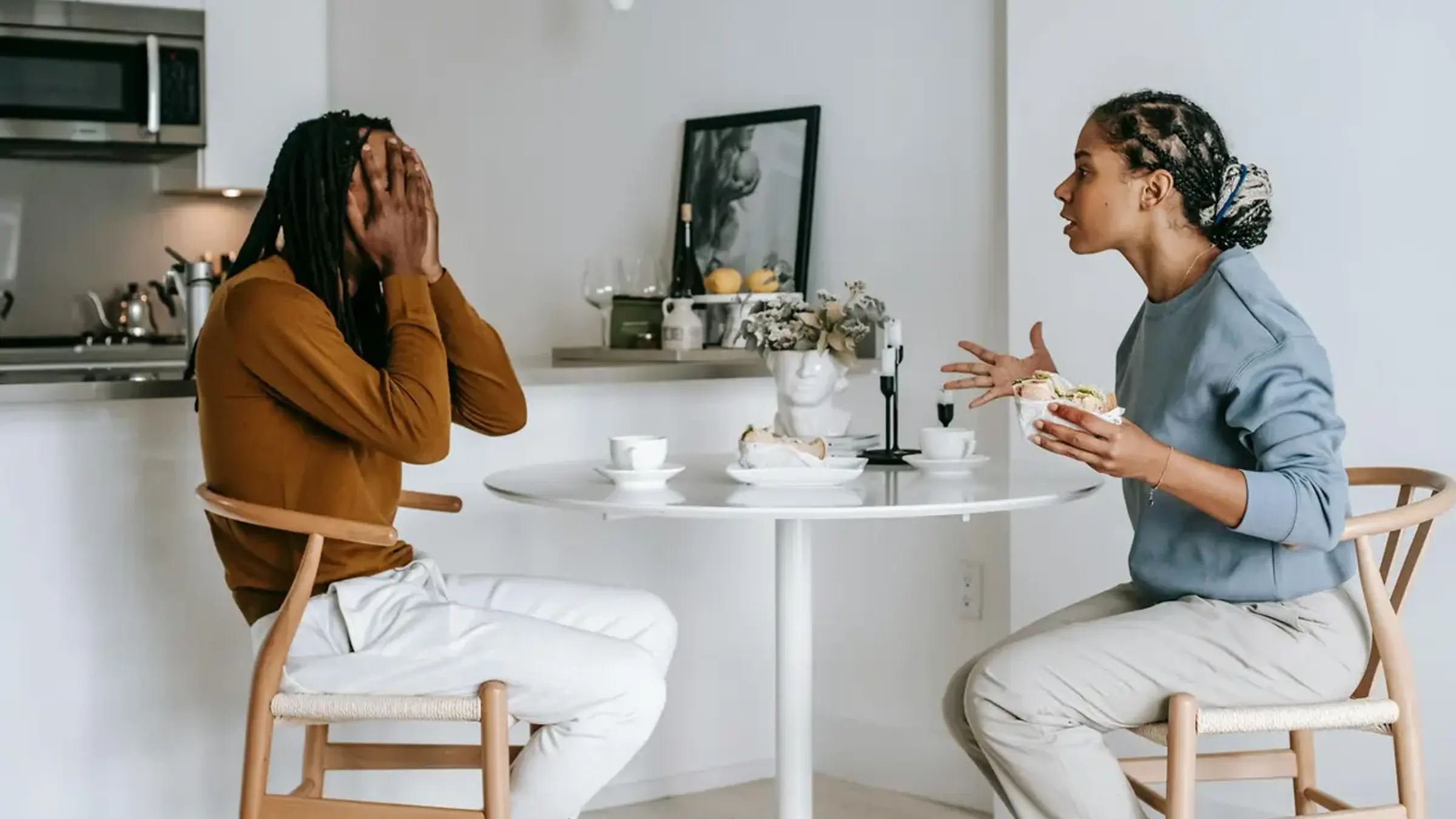 Two people sitting close together in a quiet everyday setting, having a calm conversation that suggests early dating clarity