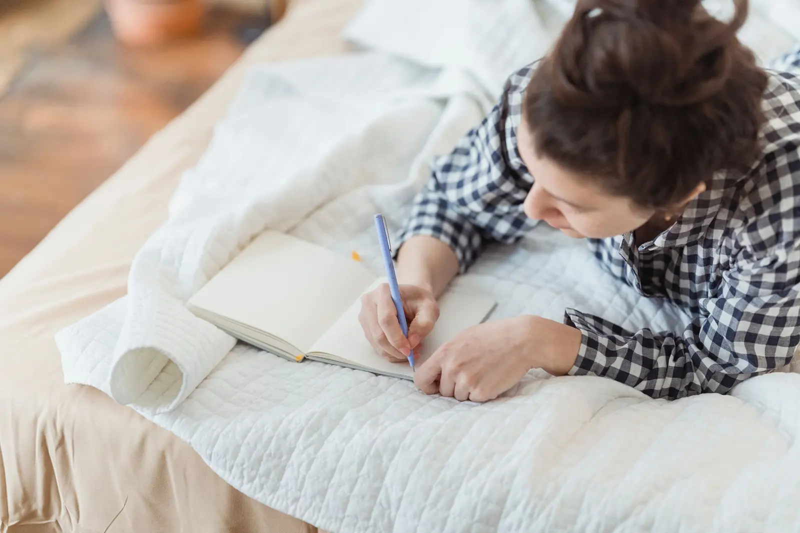 A woman writing in a journal while reflecting on relationship boundaries