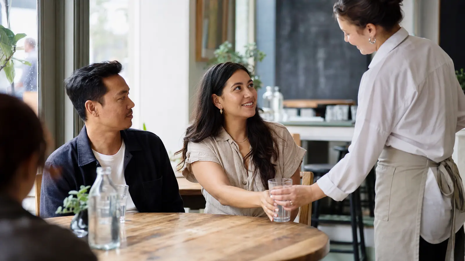 A partner observing a courteous everyday interaction with a cafe server
